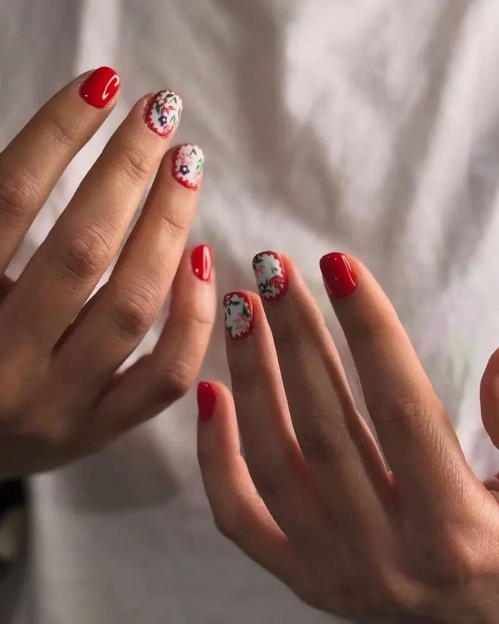Floral nail art with red accents